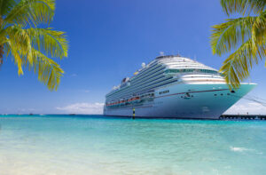 Cruise ship docked at tropical port on sunny day