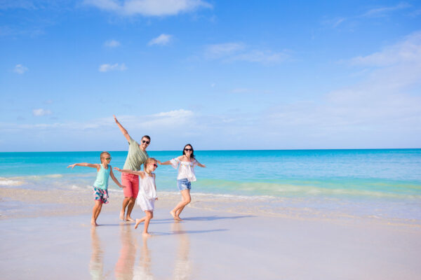 Young family of four on beach vacation